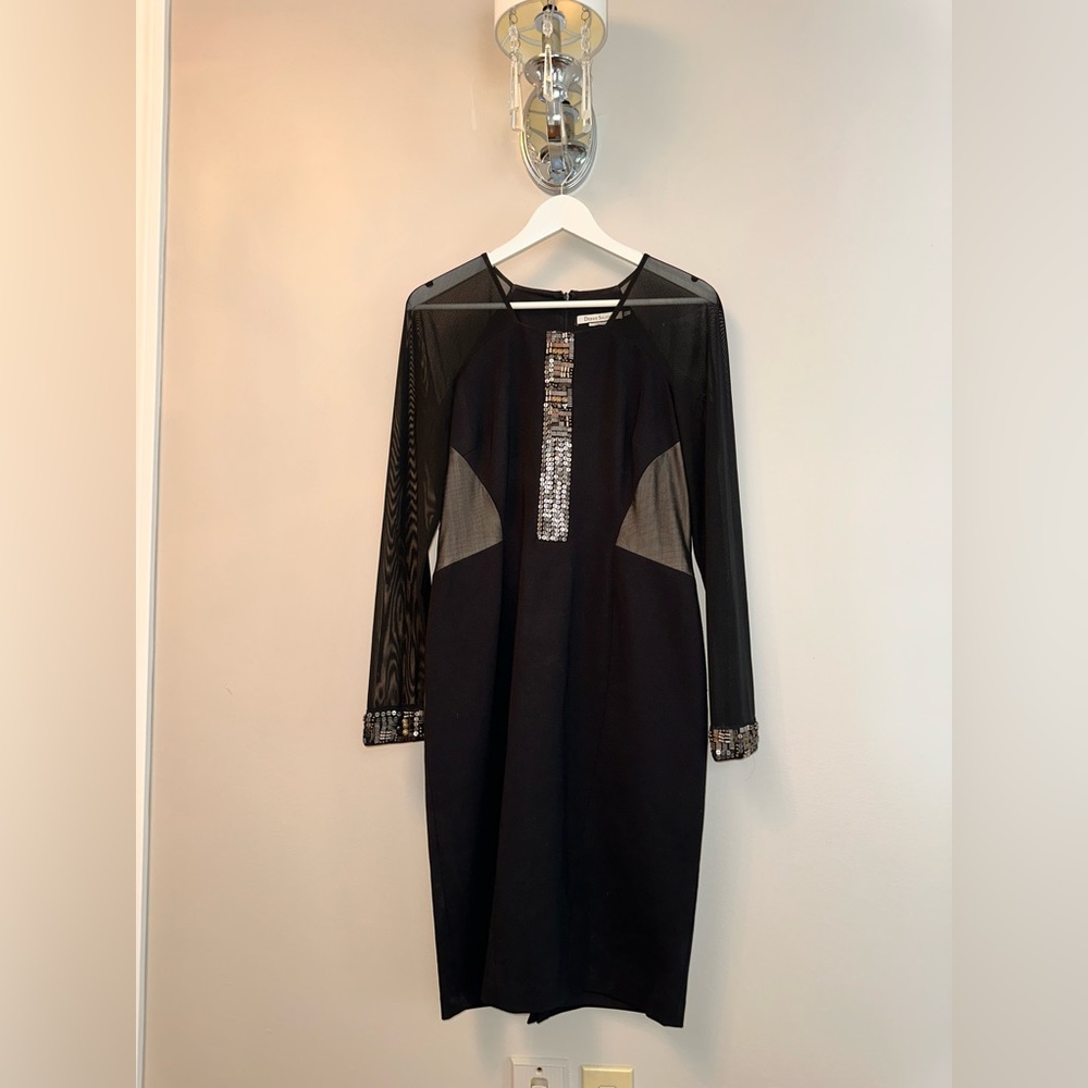 Cocktail dress black with sheer accents. Mesh sleeves.